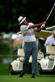 Golfer Juan Chi Chi Rodriguez swings and watches the flight of- Golf 1988 Photo