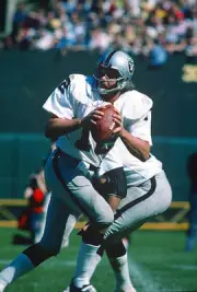 Quarterback Ken Stabler Oakland Raiders drops back to pass at an - 1976 Photo