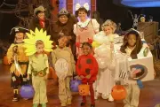 Host Megan Mullally dressed in costume as Edith Ann with crew memb- Old Photo