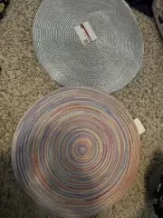 TWO SETS OF ROUND PLACEMATS ALL NEW WITH TAGS, SILVER, RAINBOW