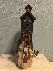 Handcrafted wooden house with singing snowmen Christmas decoration