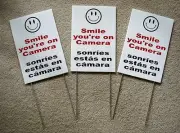 3 SMILE YOU'RE ON CAMERA SIGNS 8"x12" w/ Stakes Security Surveillance Spanish