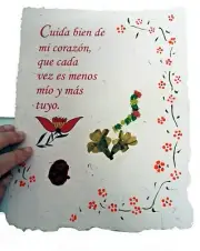 Love poem on handmade paper with rose petal