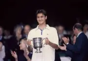 Roger Federer of Switzerland poses with the trophy after defeating- Old Photo