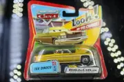 New in package- Disney Pixar Cars Diecast-Tex Dinoco with lenticular eyes