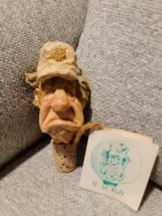 Spit N Whittles guy with golf ball in cap