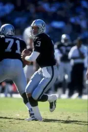 Quarterback Jeff George Oakland Raiders looks for an open receiver- Old Photo