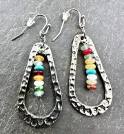 Hammered Silver Teardrop Earrings framing a Rainbow of Glass Beads