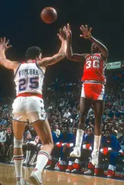 Carr Detroit Pistons passes the ball over the top of Mitch Kupchak- Old Photo