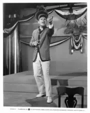 Robert Preston as Harold Hill gestures while standing alone in The- Old Photo