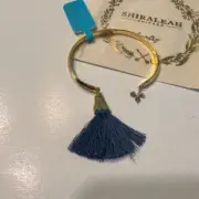 Shiraleah Chicago Gold Bangle Bracelet with Navy Blue Tassel and Charm Detail