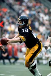 Quarterback Terry Bradshaw Pittsburgh Steelers turns to hand the - 1974 Photo