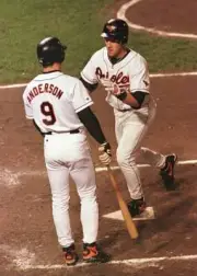 Cris Hoiles Baltimore Orioles is congratulated by teammate Brady A- Old Photo