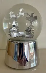Musical Christmas snow globe, silver base with silver Santa & reindeers scene