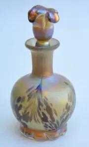 Gold Luster Perfume Bottle With Red Wave Design. Saul Alcaraz