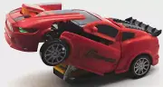 Red Robot Transforming Car( Lights up and makes Sounds) Spins and Bumps