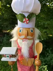 Nutcracker Pastry Chef wearing checkered apron - holding gingerbread and spoon