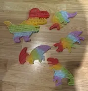 5 Pack Dinosaur Pop Fidget Toys Glow in Dark Fun Rainbow Colored Dinosaurs NEW