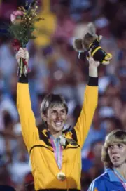 Australian heptathlete Glynis Nunn raises both arms in the air in - Old Photo
