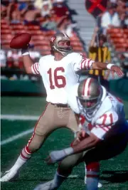 Quarterback Jim Plunkett San Francisco 49ers drops back to pass v- 1976 Photo 1