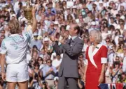 Stefan Edberg of Sweden lifts his trophy to the crowd watched by K- Old Photo