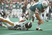 Larry Csonka Miami Dolphins runs through the tackle of Nate Wrigh- 1974 Photo