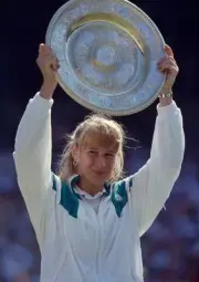Steffi Graf of Germany lifts the trophy after defeating Gabriela S- Old Photo