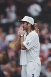 American tennis player Andre Agassi holding his hands to his face - Old Photo