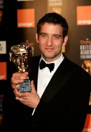 Actor Clive Owen poses with the award for Best Supporting Actor fo- Old Photo