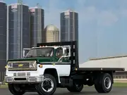 1/64 DCP WHITE/GREEN CHEVY C65 SINGLE AXLE FLATBED