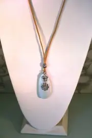 Silver tone pale blue wood pendant with crystal flowers on tan leather cord 28"