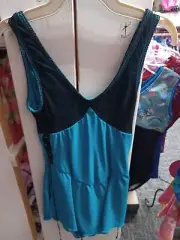 blue ice skating dress with a black top over lay