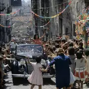 Sophia Loren in a car greeting the crowd during a scene of the fil- Old Photo