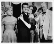 Judy Holliday looks on while Dean Martin gives Nancy Walters a big- Old Photo 1