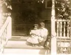 Two African American children sitting on steps to porch Illustration Old Photo