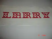 CROSS STITCHED NAME LARRY FAB PIECE IS 11.5 X 4