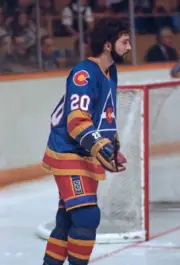 Dwight Foster of the Colorado Rockies skates against the - Ice Hockey Old Photo