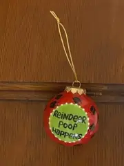 REINDEER POOP HAPPENS ORNAMENT BY OUR NAME IS MUDRED W/HOOF PRINTS GOLD HANGER