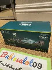 1:43 Bburago B18-38091A Fernando Alonso Lance Stroll AMR23 (with Figure + Case)